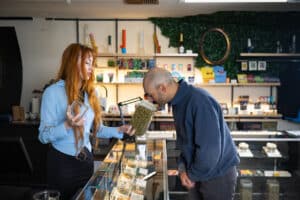 Photo of customer and employee interaction within a veteran owned cannabis dispensary in Warren County, Oregon.